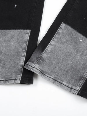 Split panel bootcut jeans in black and light gray with paint splatters.