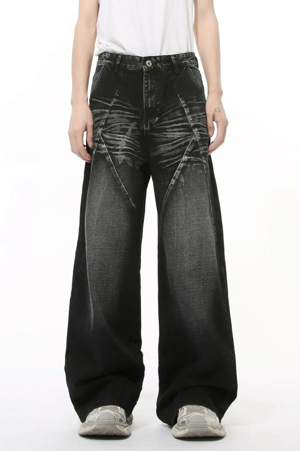 Dark wash denim jeans with wide legs and sculpted panel details.