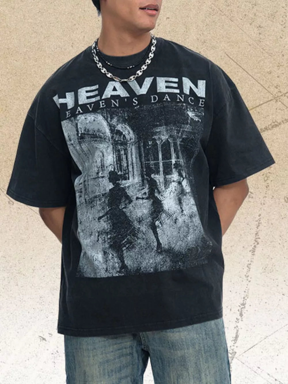 Black oversized graphic tee with crew neck and "Heaven's Dance" print.