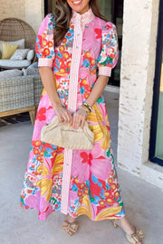 Vibrant floral maxi dress with button front, puff sleeves, and pink stripe detail.