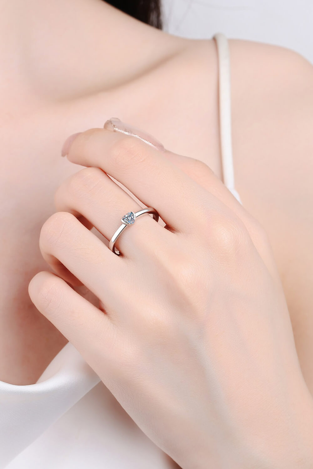 Silver ring with a heart-cut solitaire diamond on a delicate band.