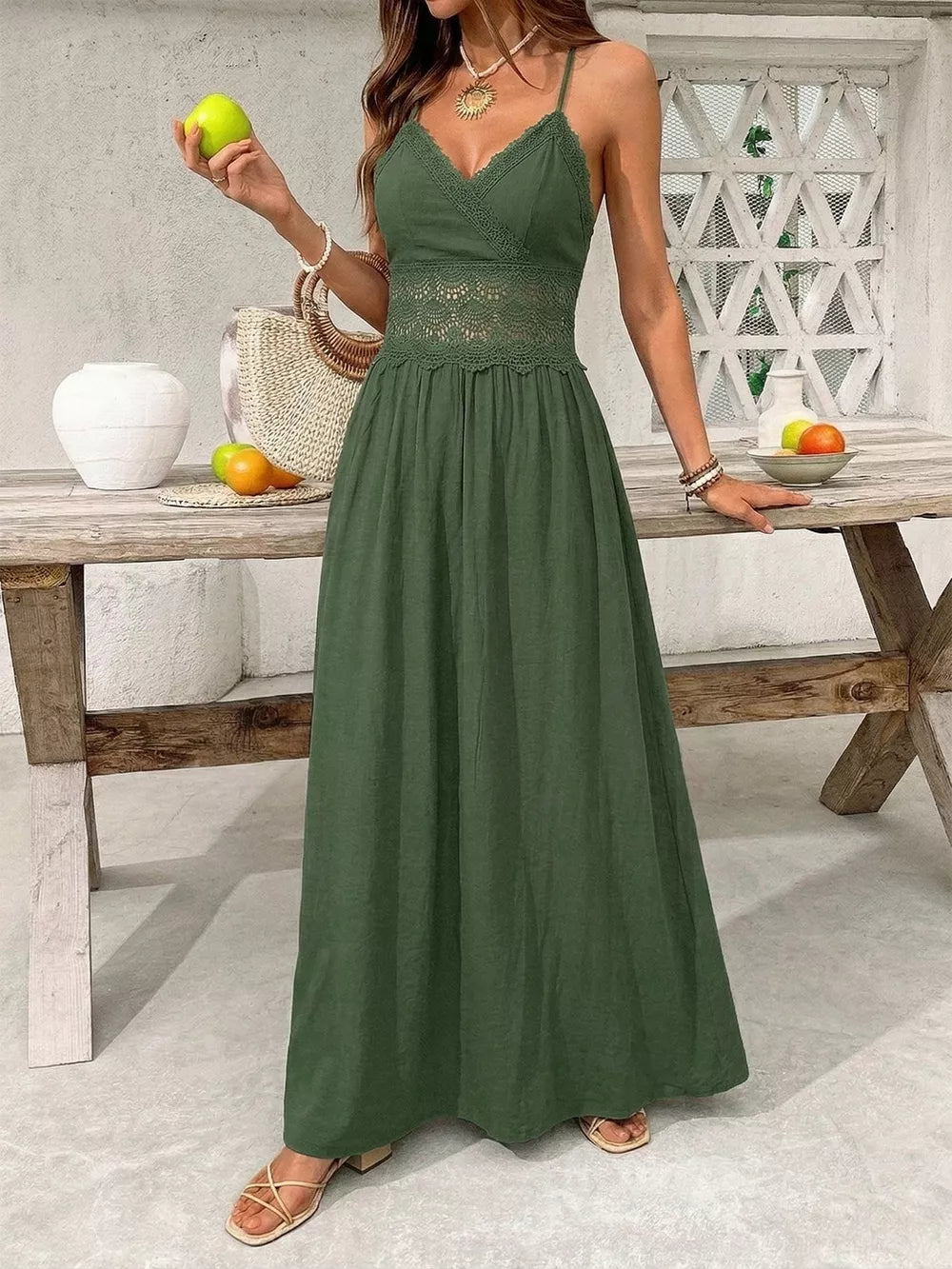Green cotton blend maxi gown with spaghetti straps, V-neck, lace cinched waist and hem.