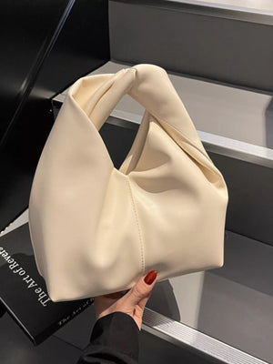 Cream leather shoulder bag with a unique knot handle and slouchy design