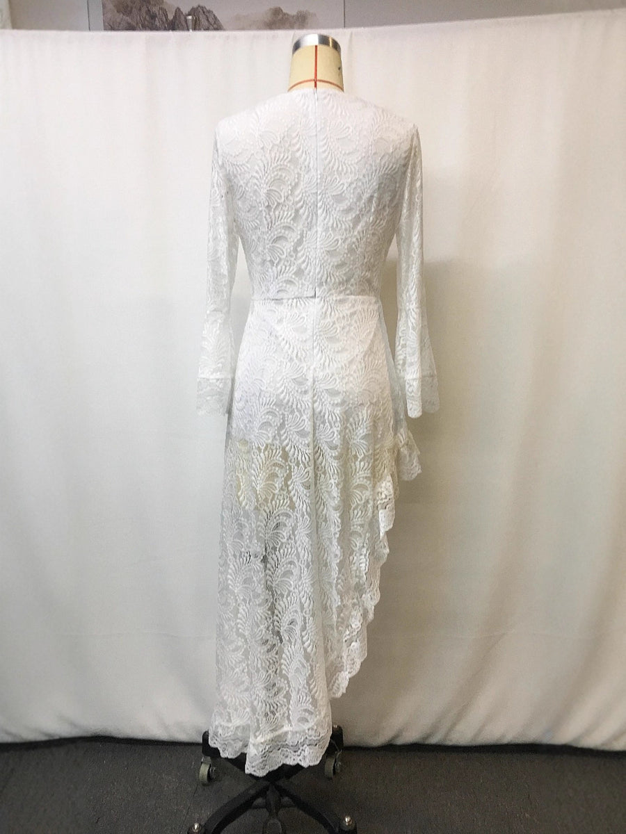 White lace asymmetrical V-neck dress with bell sleeves and ruffled hem.
