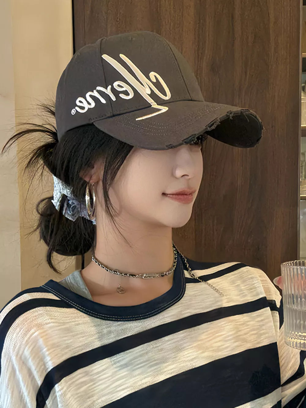 Baseball cap in charcoal grey with distressed brim and white embroidered logo.