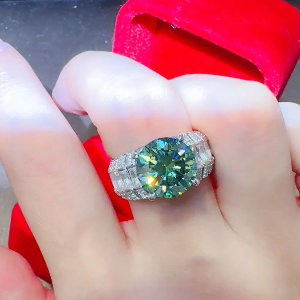 Emerald cut moissanite and silver band ring with baguette and round accent stones.