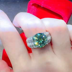 Emerald cut moissanite and silver band ring with baguette and round accent stones.