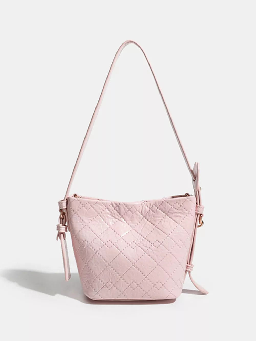 Pink quilted bucket bag with chain accent and adjustable strap