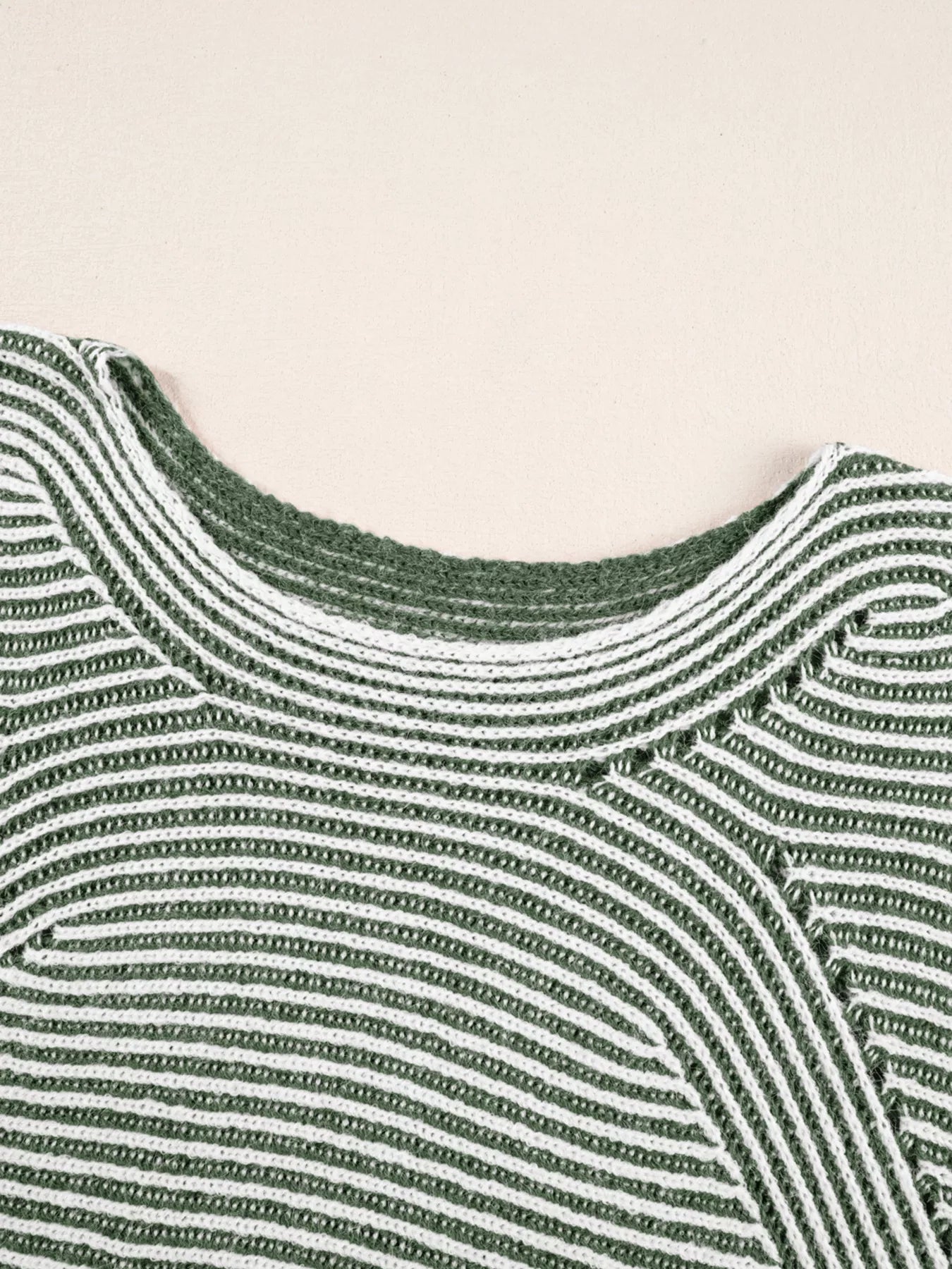 Relaxed ribbed knit sweater with boat neck in stripe pattern.