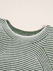 Relaxed ribbed knit sweater with boat neck in stripe pattern.