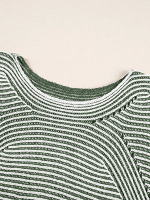 Relaxed ribbed knit sweater with boat neck in stripe pattern.