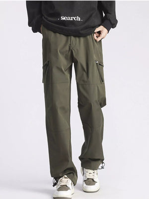 Relaxed fit green cargo pants with multiple pockets and drawstring ankles.