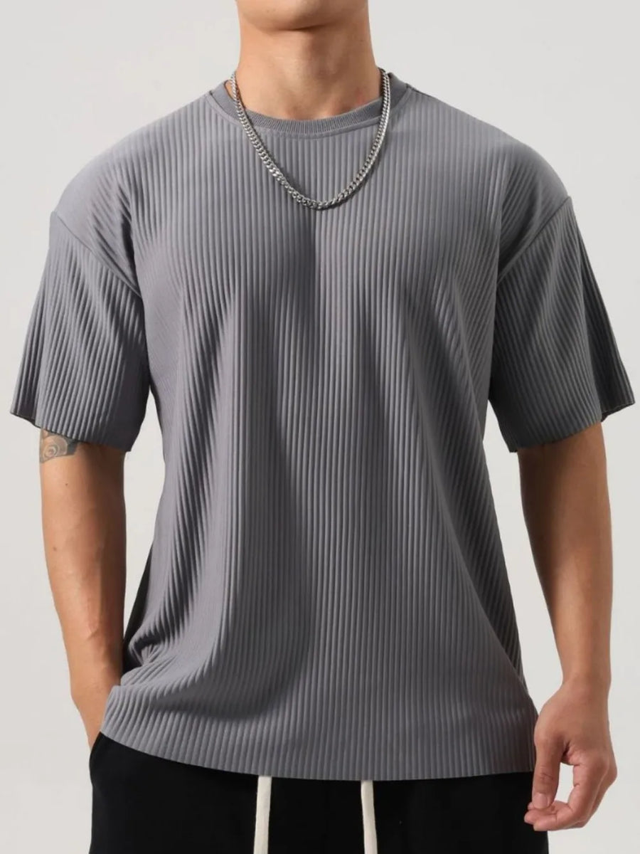 Dark gray oversized t-shirt with sculpted texture and short sleeves.