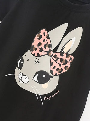 Black toddler t-shirt with a playful bunny graphic and pink leopard print bow.