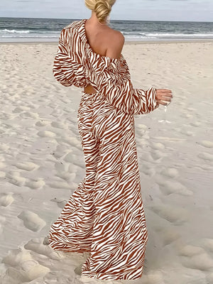 Brown zebra print relaxed two-piece set with off-the-shoulder top and wide-leg pants.
