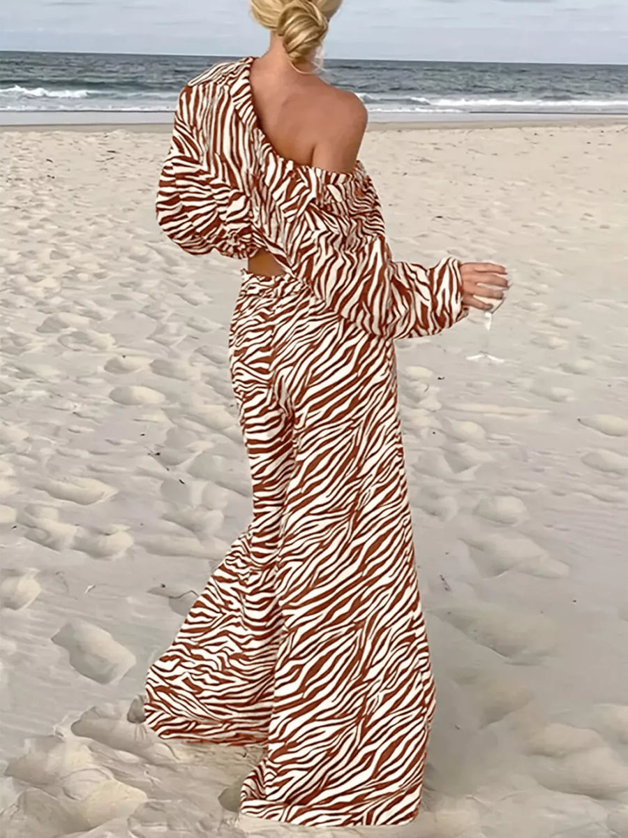 Brown zebra print relaxed two-piece set with off-the-shoulder top and wide-leg pants.