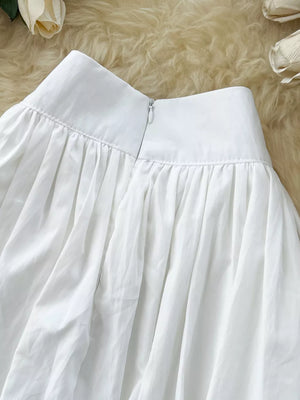 White gathered waist high-waisted skirt with zipper closure and pockets.