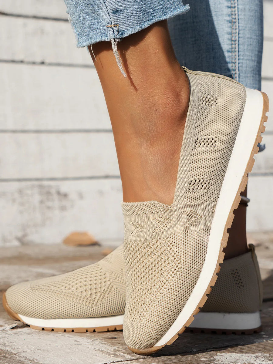 Breathable knit slip-on sneakers in beige with a diamond pattern detail.