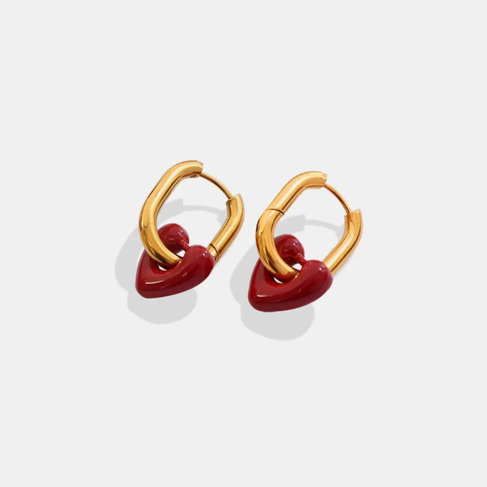 Gold hoop earrings with red enamel heart charms