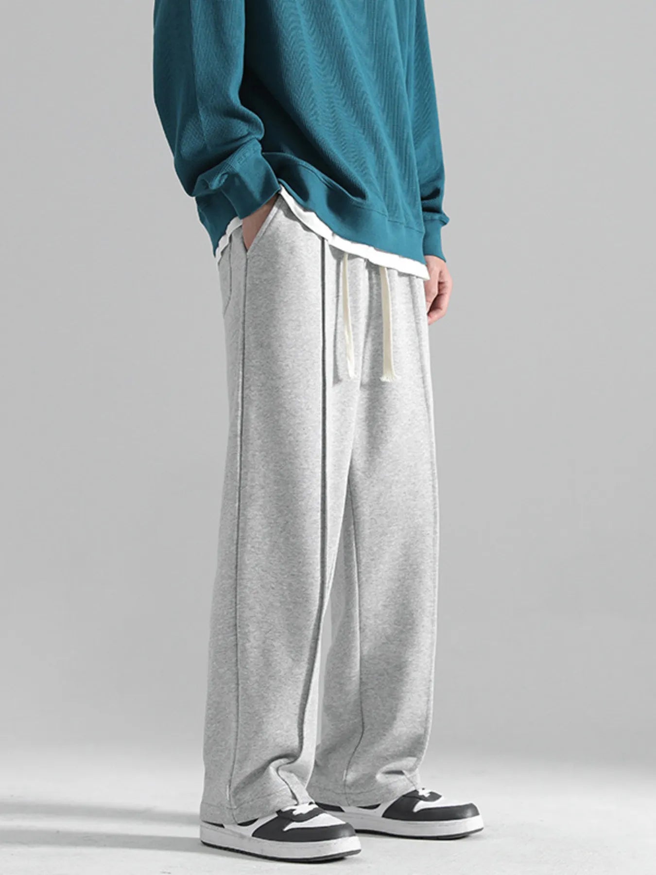 Grey casual drawstring sweatpants with a loose fit and contrast stitching.