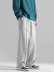 Grey casual drawstring sweatpants with a loose fit and contrast stitching.