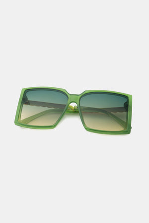 Green geometric sunglasses with gradient lenses and a bold square frame.