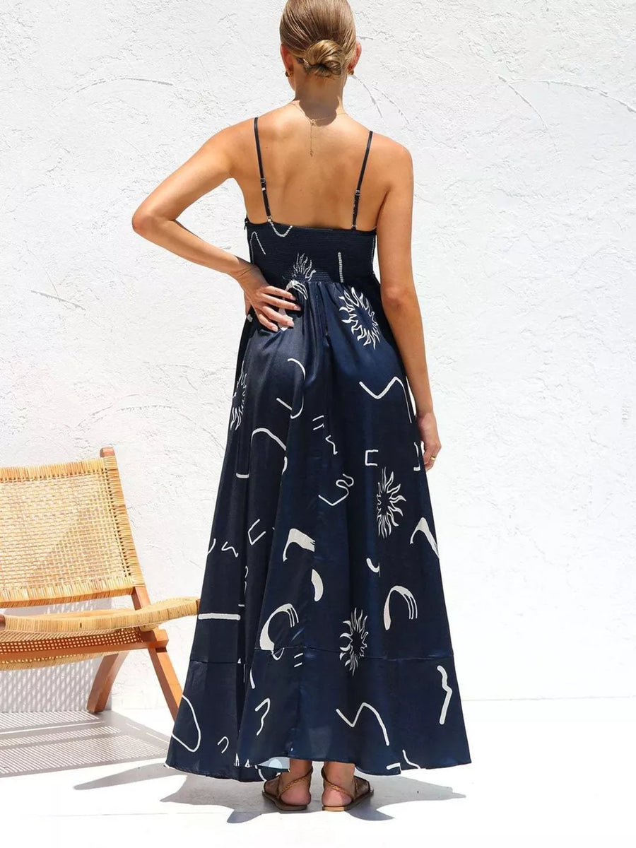 Dark Navy maxi dress with abstract white print, spaghetti straps, and a flowy skirt.