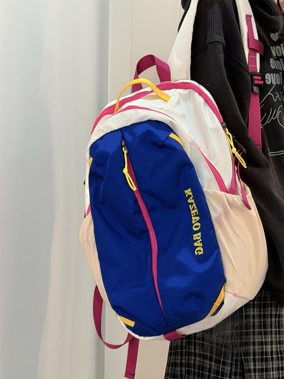 Medium nylon casual backpack in white, blue, and beige with pink and yellow accents.