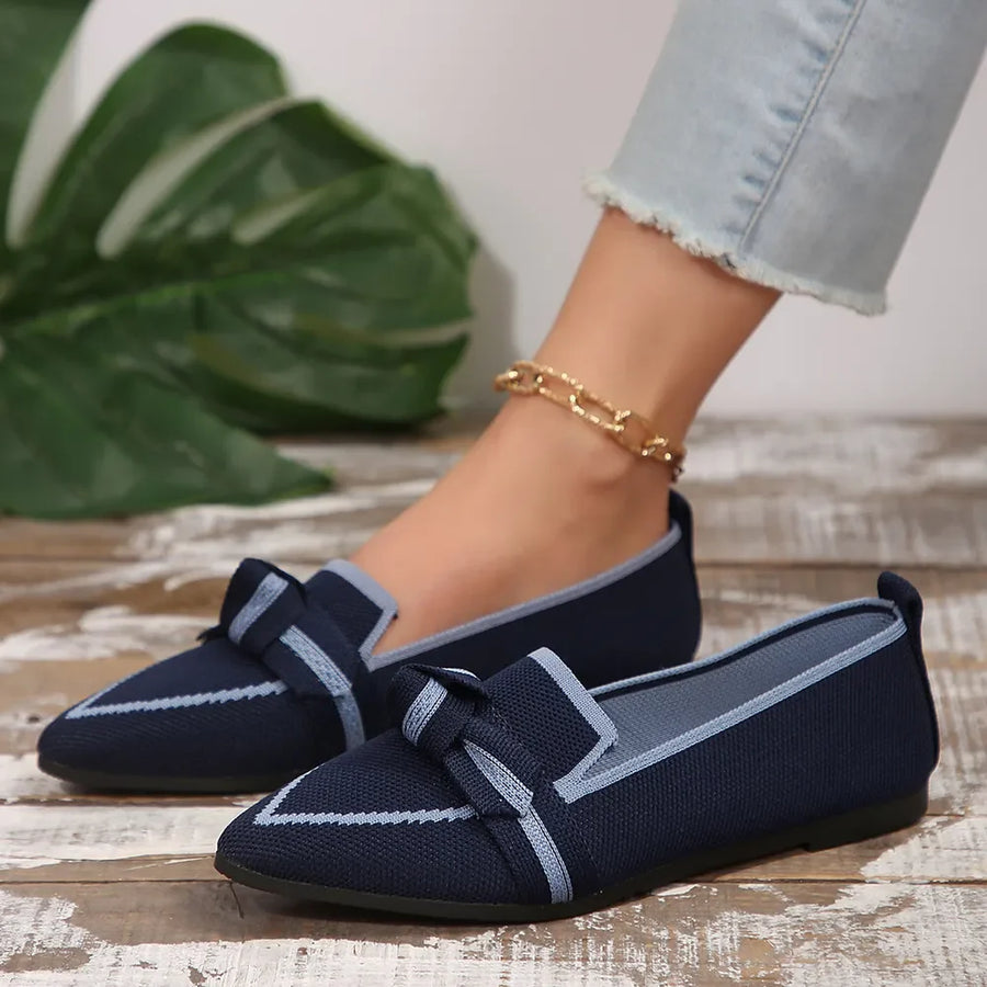 Dark blue knit bow loafers with contrast trim and pointed toe.
