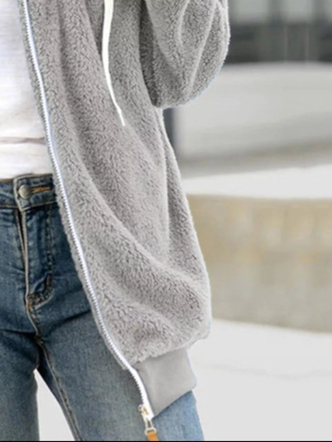 Light gray cozy fleece zip-up hooded jacket with white drawstring and zipper detail.
