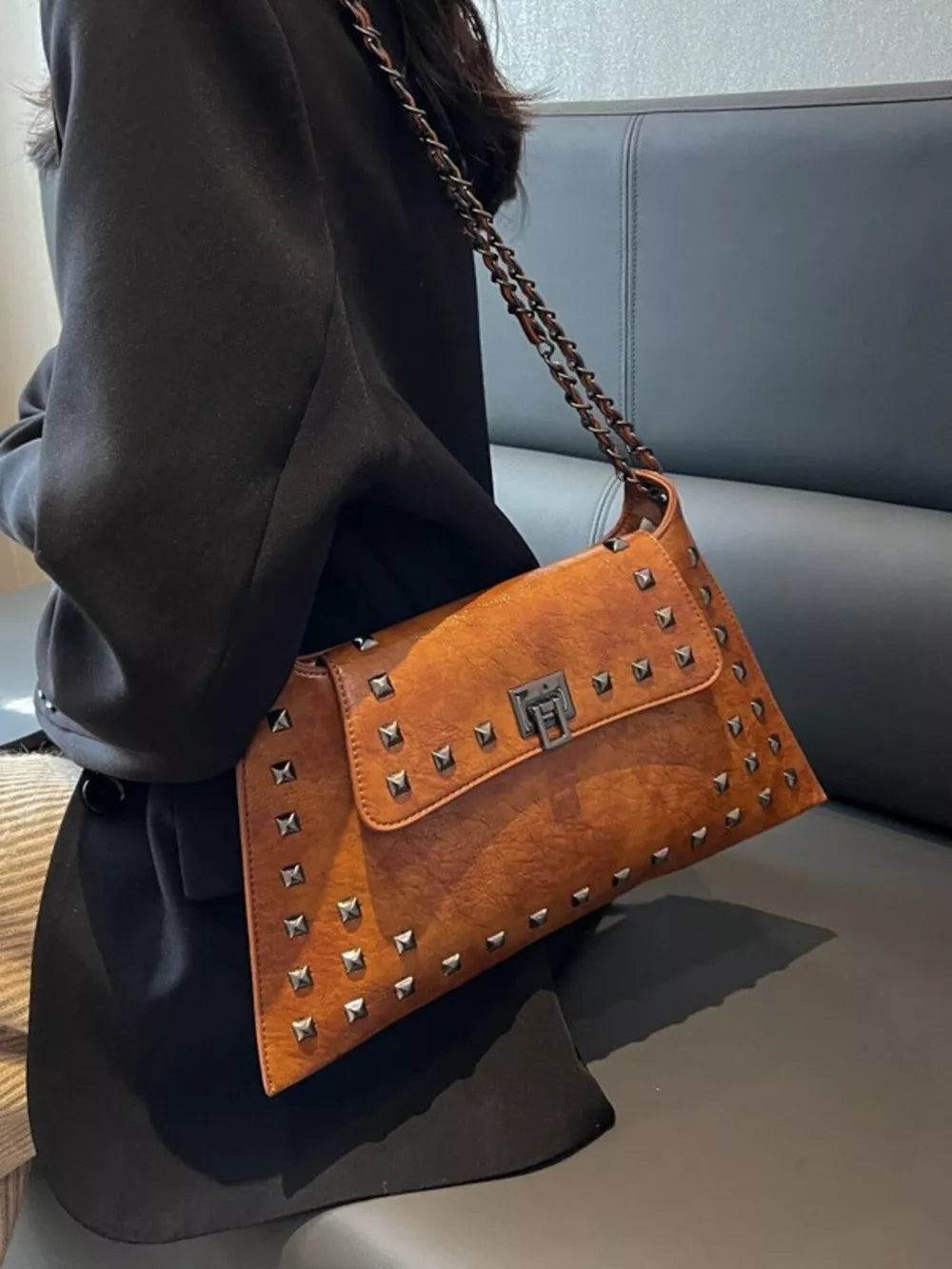 Brown embellished chain flap shoulder bag with silver studs and a metal clasp.
