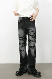 Distressed flare jeans in dark shadow wash denim with a bootcut leg.
