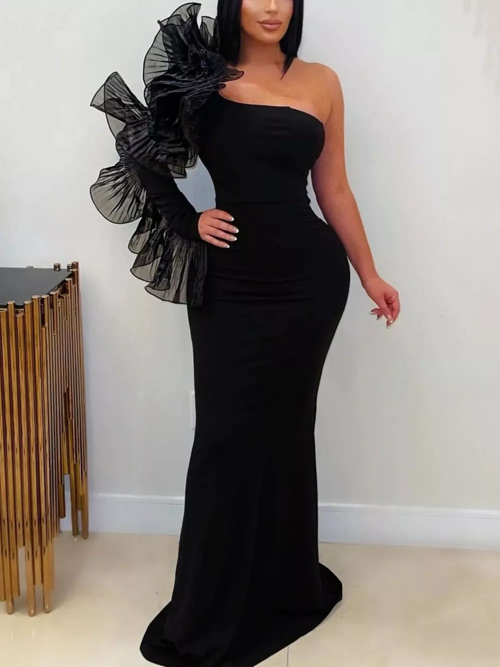 formal gown in black featuring ruffled and flared fit