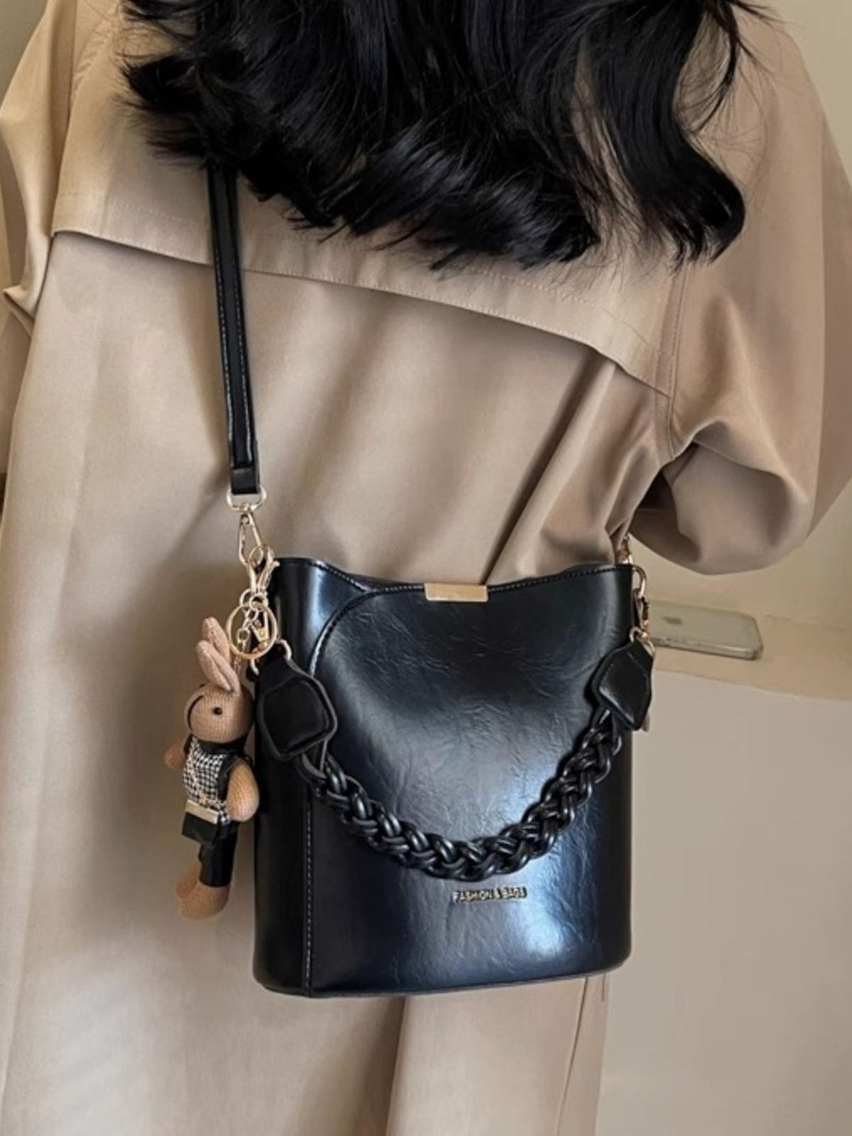 Black braided bucket crossbody bag with a bunny charm