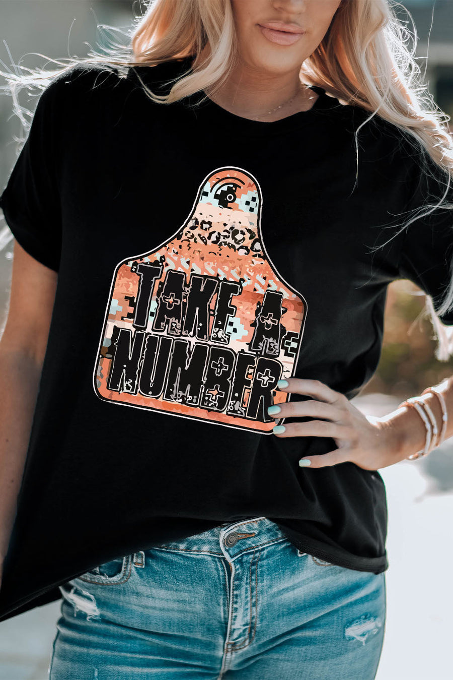 Black graphic tee with Take A Number design on a tag shape