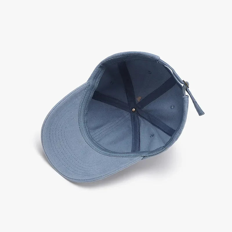 Distressed denim baseball cap in light blue with adjustable strap and interior details.