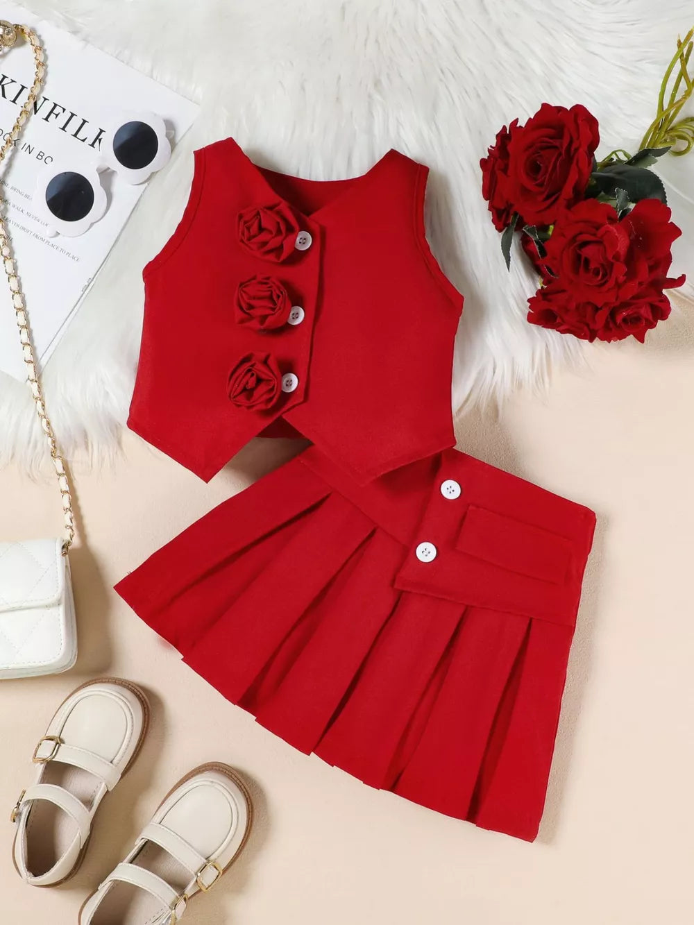 Red floral vest and pleated skirt outfit with decorative buttons