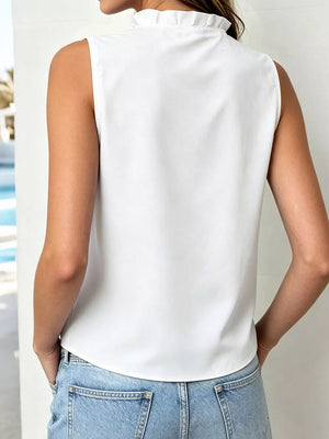 Sleeveless white ruffle v-neck blouse with button detail.