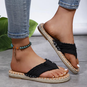 Black frayed denim espadrille thong sandals with jute trim and a beaded anklet.