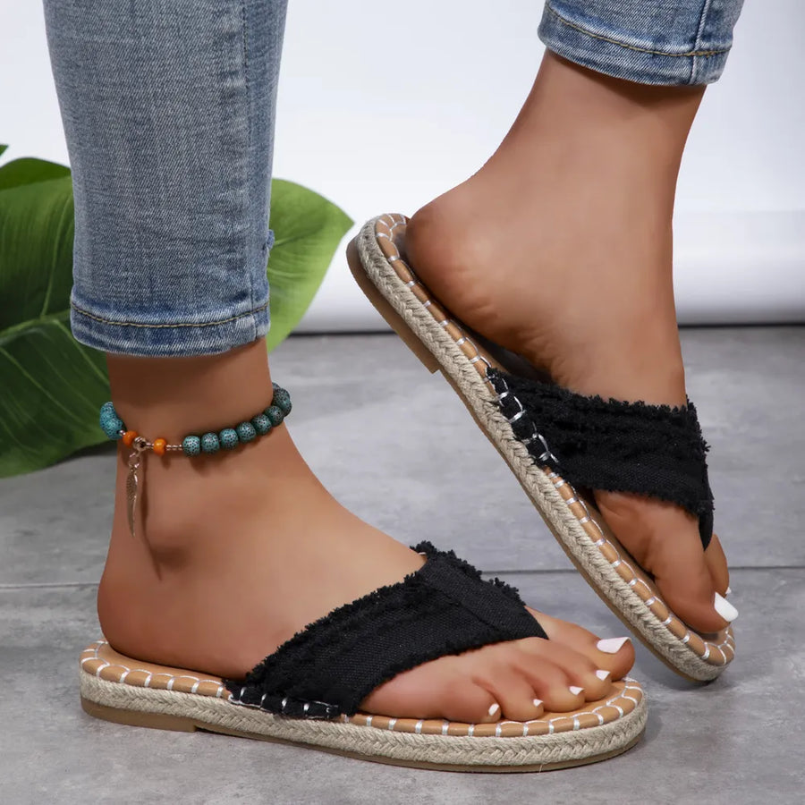 Black frayed denim espadrille thong sandals with jute trim and a beaded anklet.