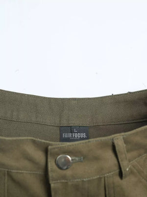 Olive green cotton cargo pants with button fly and visible brand tag.