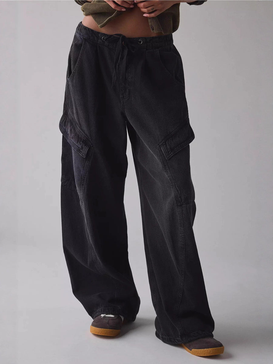 Black denim cargo jeans with drawstring waist and large side pockets.