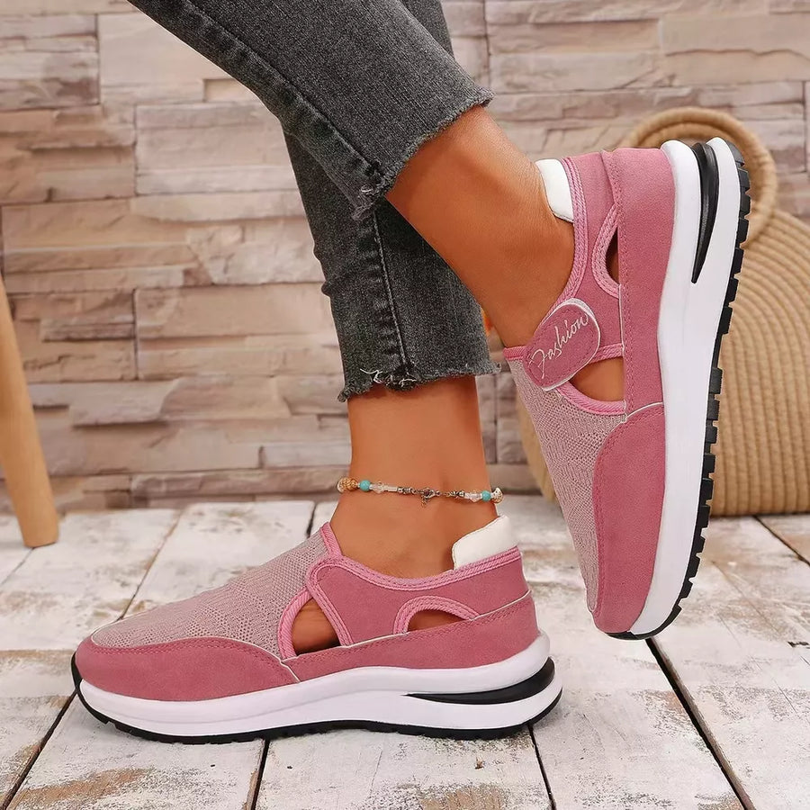 Pink breathable cutout slip-on sneakers with mesh panels and a white heel detail.