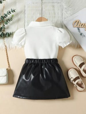Baby girls' white puff sleeve top with black faux leather skirt set.