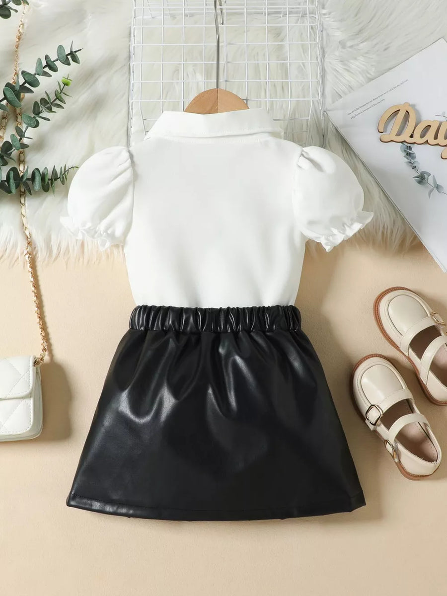 Baby girls' white puff sleeve top with black faux leather skirt set.