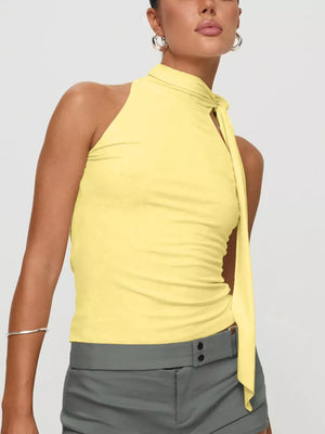 Yellow halter neck top with tie detail, sleeveless, soft fabric.