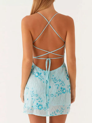 Pastel blue mini dress with floral beading and crisscross back straps.