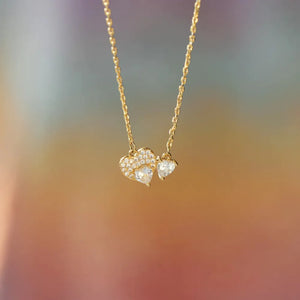 Duo heart zirconia necklace in gold with delicate chain and pavé details.