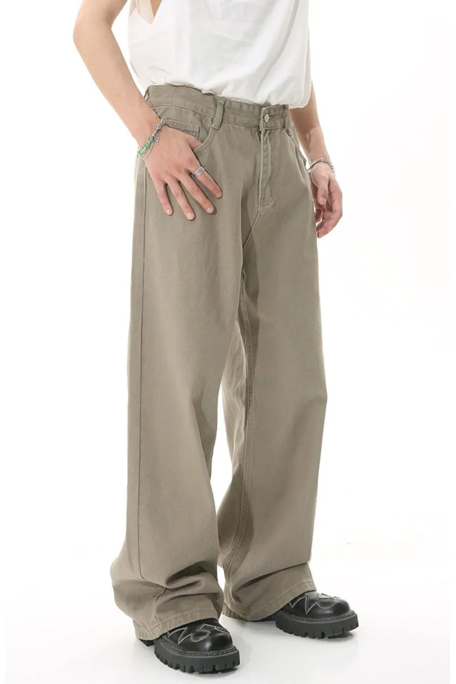 Khaki wide-leg denim jeans with a relaxed fit, shown on a model with jewelry.