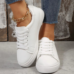 White leather-look platform sneakers with lace-up closure and gold chain anklet